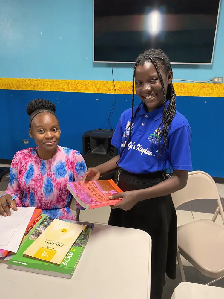 A student receiving books
