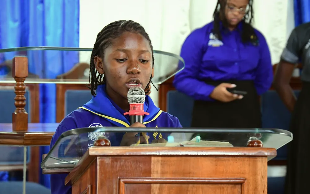 A young missionary reading at the pulpit