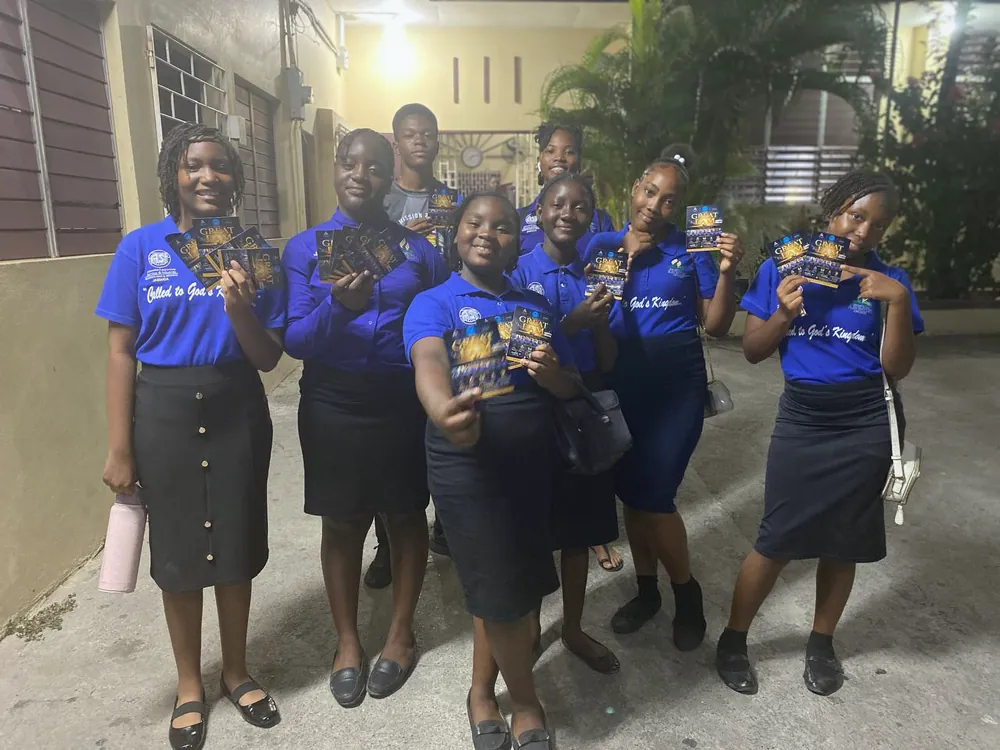 Members holding Great I Am flyers
