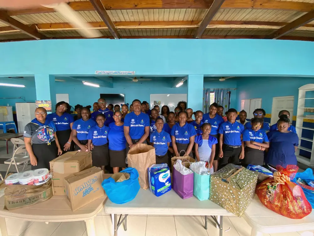 Missionaries with bags and gifts laid out on tables